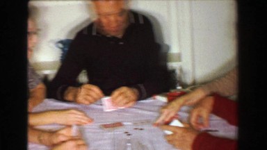 1957: Family Playing Poker Cards After Thanksgiving Dinner at Kitchen Table.