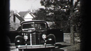 1939: Pontiac 4 door sedan car backing out of driveway front hinged rear door