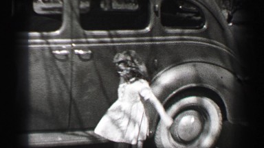 1939: Wealthy young girl wavy curly long bangs hair style doll closes car door
