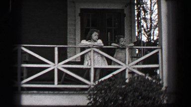 1939: Wealthy young girls in white formal sun dress leaving southern mansion