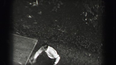 1937: Outdoor table tennis game aerial pov man playing in formal dress clothes.