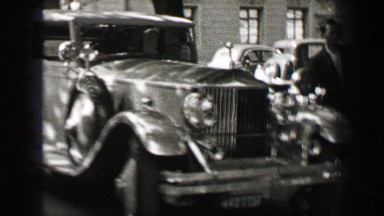 1937: Rolls Royce classic car marveled at by men at elite castle villa. HAMBURG,