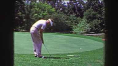 1968: Man Chips Golf Ball from Green Fringe, Drops in Hole as Onlooker Reacts in Amazement