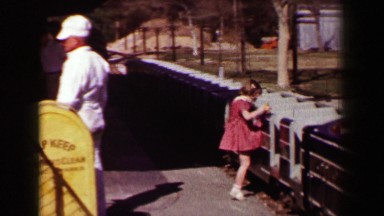 1957: Mini Locomotive Railroad Train Takes Young Girl and Mom Around Park