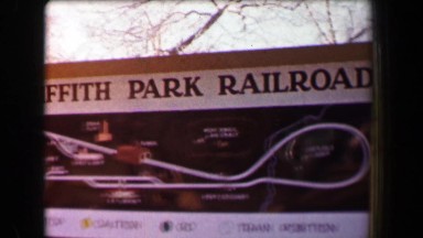 1968: Griffith Park Railroad conductor loads mini train kids into recreational