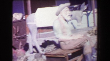 1968: Old mining tourist display town fake gold painted rocks mucking carts.