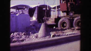1968: Wrecking ball crane breaking packing rock backfill dirt solid. BILOXI,