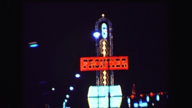 1969: Nighttime Casino Signs Frontier, Desert Inn, Caesars Palace, Dunes