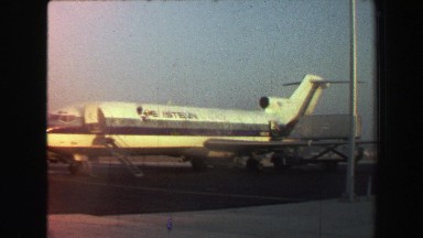 1969: Eastern Airlines Airplane Parked on Tarmac at Freeport, Bahamas Waiting to Board