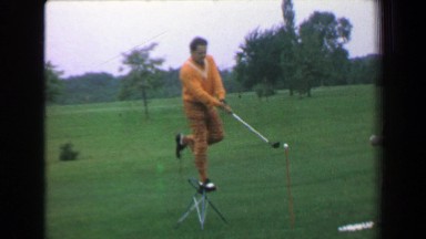 1969: Golfing Trick Shot Professional Performance Man Standing on Chair Hitting