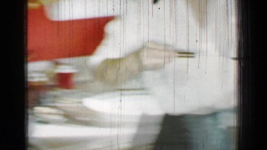 1958: Mom prepares Thanksgiving turkey dinner taking bird out of cooking pot.
