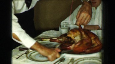 1958: Man carving Thanksgiving dinner turkey removes drumstick leg. ST. LOUIS,