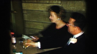 1958: Adults enjoying cigarettes cocktails after formal wedding event. ST.