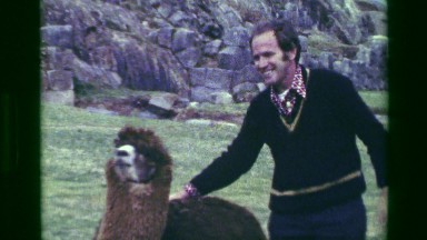 1977: Man Petting Llama at Saksaywaman Inca Ruins Clowning Around on Sacred Ground