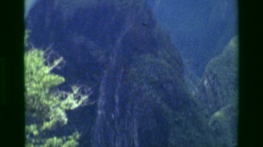 1977: Jungle Machu Picchu coated green forested mountains river below. CUSCO,