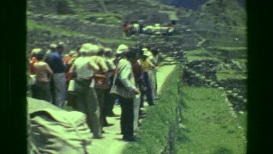 1977: Tourist crowds Machu Picchu native Inca civilization large site ruins.