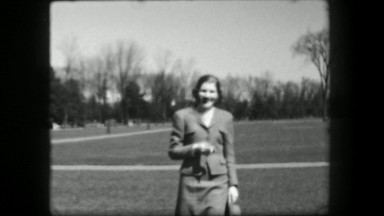 1938: Liberated woman smoking cigarette in public park outdoor proudly. SARATOGA