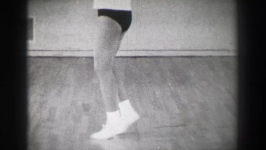 1966: Jazz dance moves 6 closeup behind kick stepping shuffle slide. NEW YORK