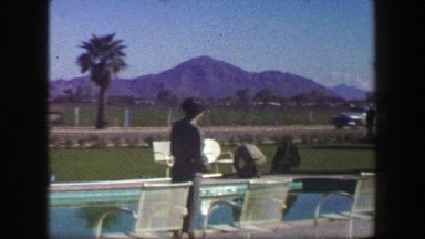 1947: Roadside hotel lounge area desert mountain range country club pool area.
