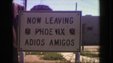 1949: Now leaving Phoenix adios amigos roadside travel tourist sign. PHOENIX,