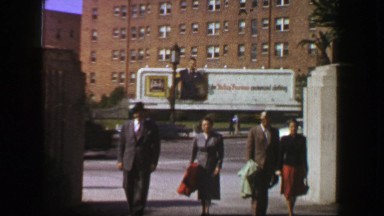 1957: Family walking 50s style advertisement billboard background. LOS ANGELES,