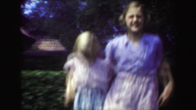 1949: Sisters dancing outdoor garden blond caucasian girls enjoying summer.