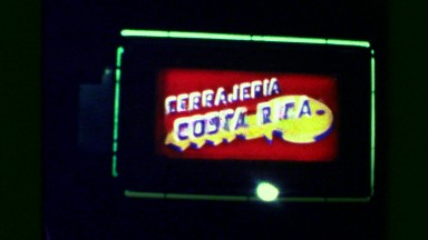 1976: Cerrajeria neon light sign flashing nighttime urban city lights. SAN JOSE,