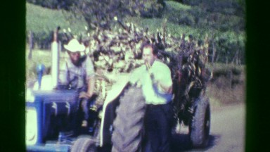 1976: Gringo building report with sugar cane farmer on tractor. SAN JOSE, COSTA