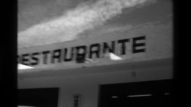 1976: Restaurante Bonanza sign building dark clouds eerie look. SAN JOSE, COSTA