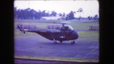 1944: US Army helicopter landing important military general escorted to safety.