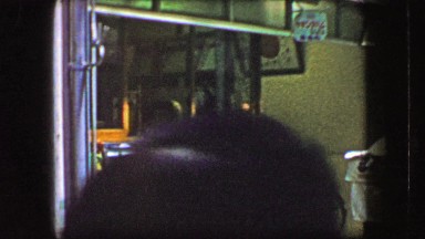 1944: Asian style bakery counter market busy people passing front display case.