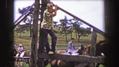 1956: Teenage rascal farmhand boys standing on ranch horse fence.