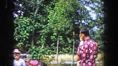 1956: Dad putting cute toddler son on 1st pony ride around country farm.