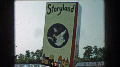 1955: Storyland theme park entrance sign mother goose storybook characters.