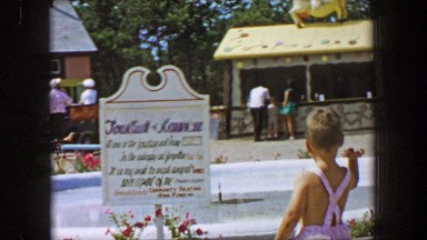 1955: Fountain of Happiness boy throws coin into water fountain, Storyland theme