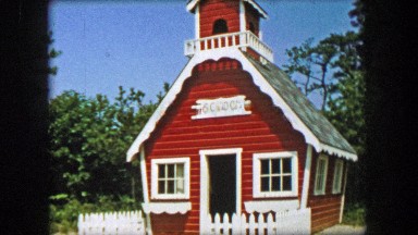 1955: Storyland theme park old red schoolhouse educational building structure.