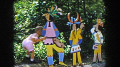 1955: Storyland theme park boy admires Native American indian motif wood