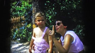 1955: Mother Teaching Boy About Birds Pointing Up in Wooded Forest Park