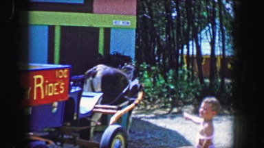 1955: Storyland theme park 10 cent pony rides kids loading into horse cart.