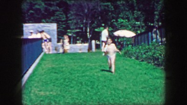 1957: Kid running towards mother public park down green grassy slope. GLEN, NEW