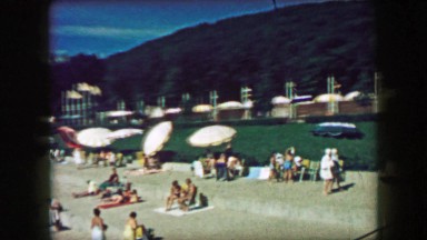 1957: Classic public pool area folks basking on a lazy summer day. GLEN, NEW