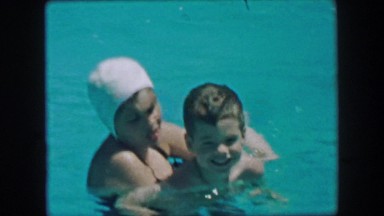 1957: Mother son training swimming closeup in calming blue waters. GLEN, NEW