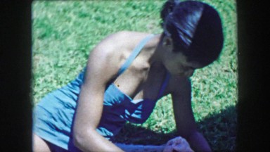 1957: African American black teenage girl caring for caucasian white baby. GLEN,