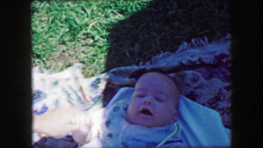 1957: Happy baby tickled smiling blanket outdoor summer playtime. GLEN, NEW