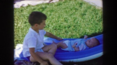1957: Baby brother calls out for mom's help caring for infant baby. GLEN, NEW