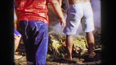 Uncovering Pig Roast at Hawaiian Luau in Honolulu, Hawaii