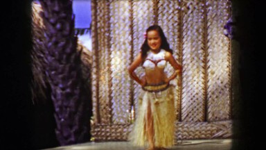 1958: Young girl hula dancer stage performing with hip shaking style. HONOLULU,