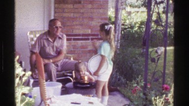 1958: Dad Churns Ice Cream With Daughter Outside