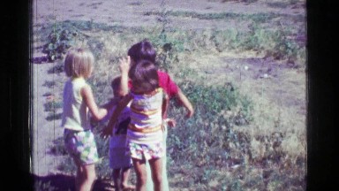 1957: Kids playing brother gets angry and punches at sister country rural