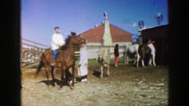 1961: grandma rides a horse on a beautiful sunny day at the ranch IOWA